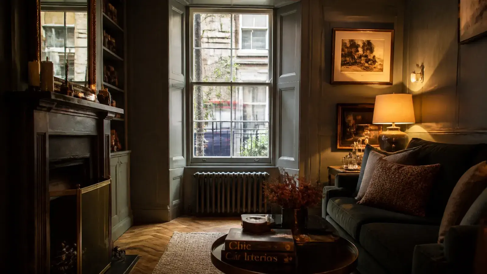 Lower-ground basement flat living room with street-level light entering through a heritage sash window fitted with discreet secondary glazing