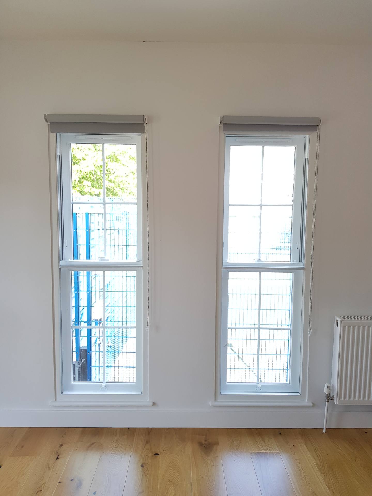 Victorian living room with large sash windows fitted with acoustic secondary glazing for railway noise reduction