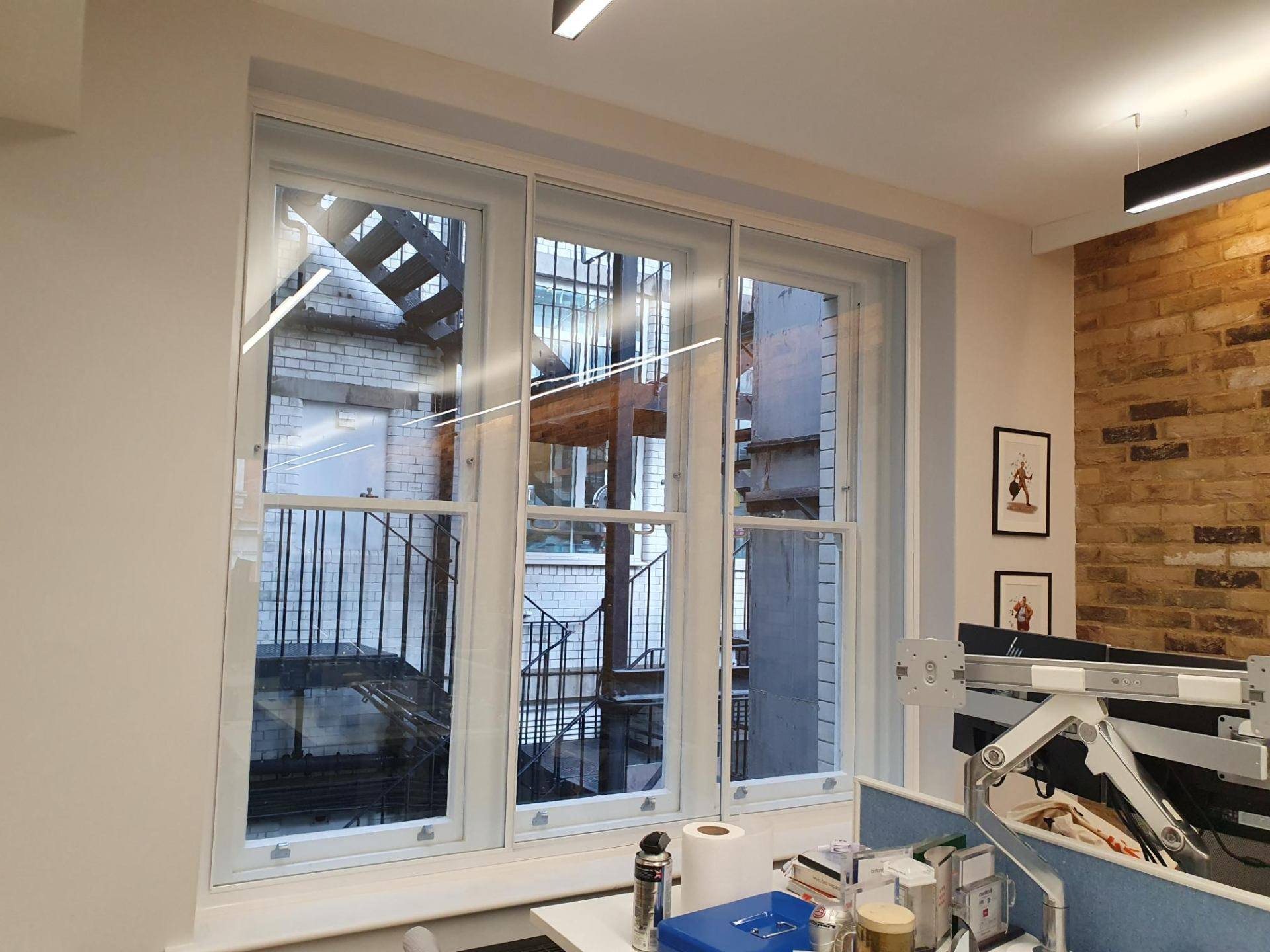 Busy London street view through soundproofed window demonstrating traffic noise reduction benefits